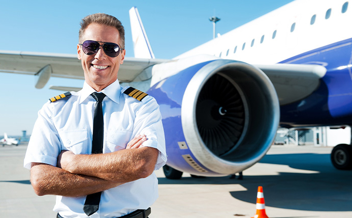 Young girl about to fly a plane with an instructor next to her.